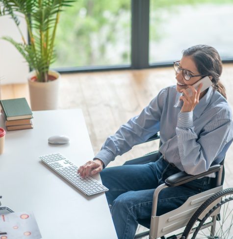 A disabled young woman talking on the phone